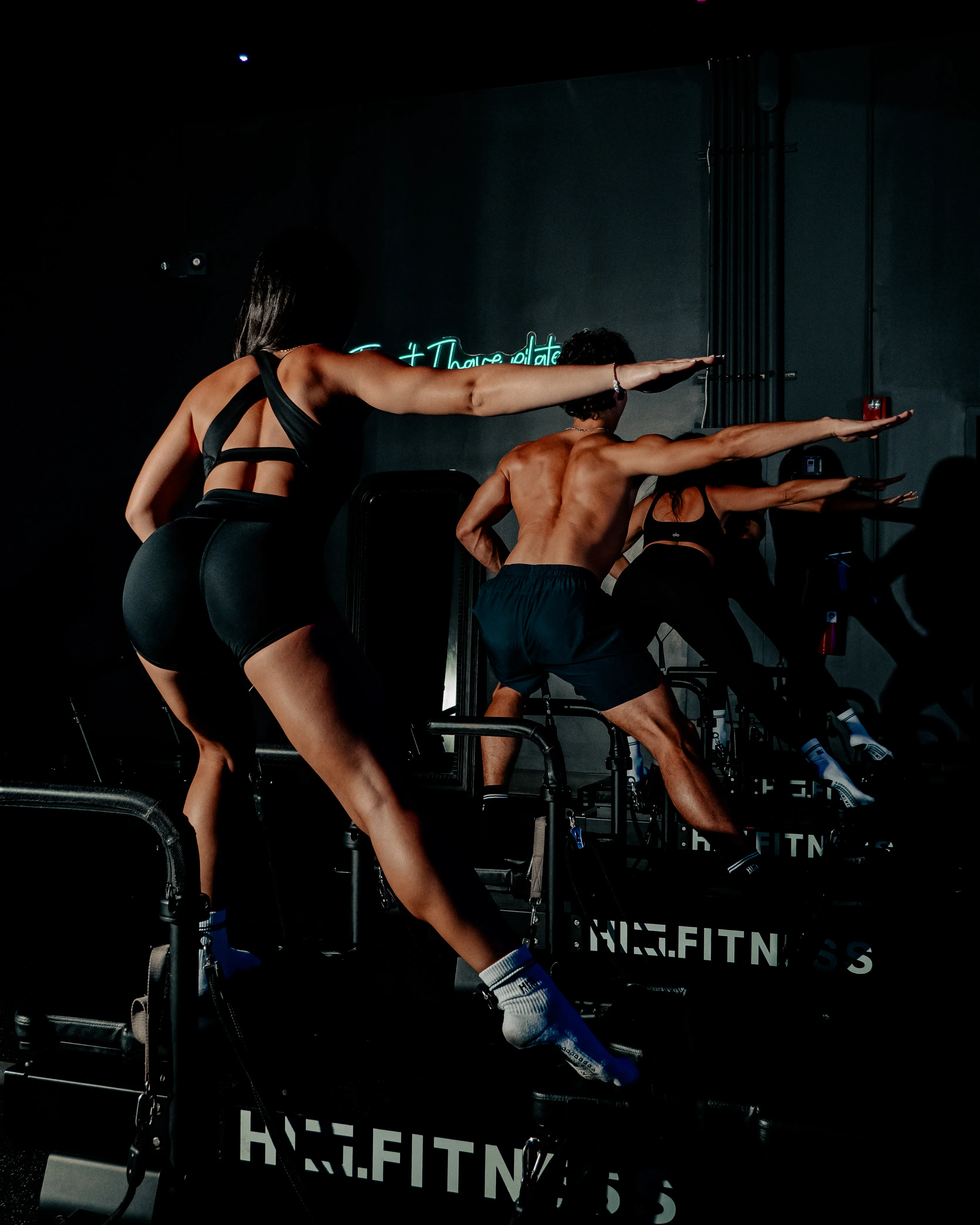 A member training inside a HILI studio under blue neon lighting